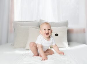 laughing baby wearing white shirt